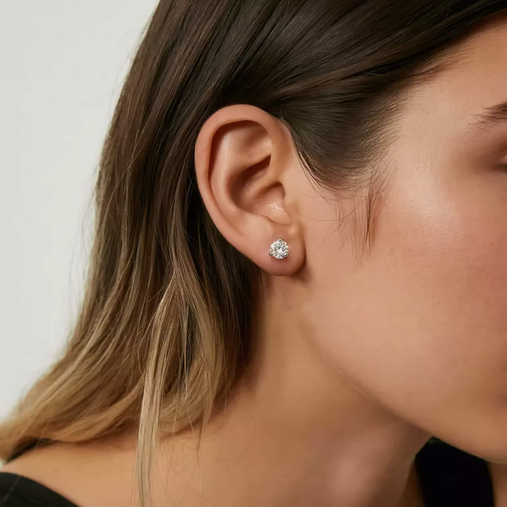 Lab-grown diamond martini (3-prong) stud earrings, 1.50 ctw, 14K white gold, on ear.